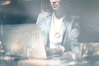 Businesswoman working on a laptop city background