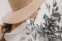 Woman in sunhat, exploring garden closeup portrait