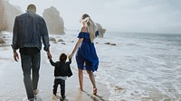 Interracial family walking along the beach in California