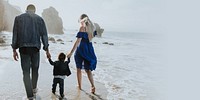 Interracial family walking along the beach in California design space 