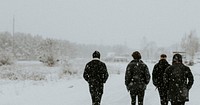 Group of men walking in the snow