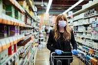 Woman in a face mask wearing latex gloves while shopping in a supermarket during coronavirus quarantine