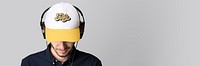 Man with a white cap mockup and headphones on a gray background