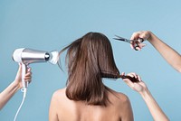 Woman getting a haircut and blow drying her hair 
