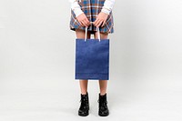 Woman carrying a blue shopping bag