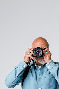 Senior man with a digital  camera 