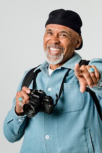 Happy senior man with a digital camera