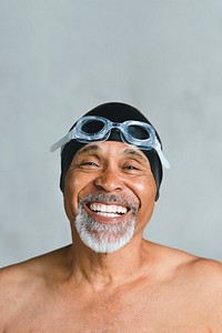 Cheerful senior man wearing swimming glasses