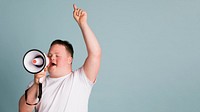 Cute boy with down syndrome using a megaphone to amplify his voice  