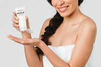 Cheerful woman squeezing cream from a tube mockup