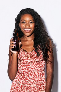 Happy black woman holding a beer bottle