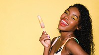 Happy black woman having an ice pop