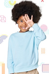 Black boy wearing blue sweater in studio