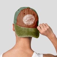 Teenage boy in brownish green cap with Camping typography street fashion shoot