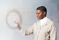 Woman analysing binary code on virtual screen