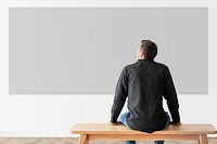 Man looking at blank wall rear view