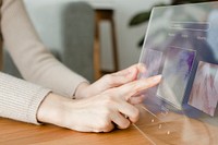 Woman using transparent tablet to play the music innovative technology