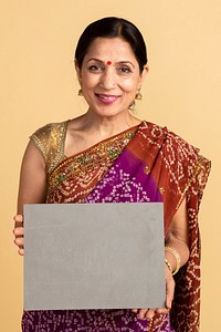Indian woman in a traditional saree holding a paper mockup 