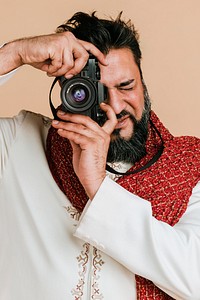 Indian man in a kurta with a digital camera 