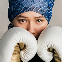 Young Islamic woman wearing a bandana while boxing