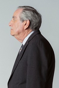 Senior businessman wearing a suit in a profile view