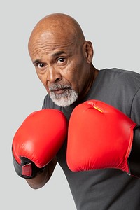 Senior man with red boxing gloves