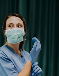 Beautiful female doctor wearing medical gloves