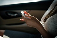 Businesswoman checking her phone during a car ride