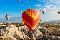 Colorful hot air balloons fly and float over a desert landscape. Original public domain image from <a href="https://commons.wikimedia.org/wiki/File:Hot_Air_Balloon_Ride_(Unsplash).jpg" target="_blank" rel="noopener noreferrer nofollow">Wikimedia Commons</a>