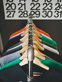 Colorful t-shirts on hangers in a clothing store. Original public domain image from Wikimedia Commons