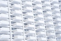 A stern white building facade with identical balconies. Original public domain image from <a href="https://commons.wikimedia.org/wiki/File:Stern_white_balconies_(Unsplash).jpg" target="_blank" rel="noopener noreferrer nofollow">Wikimedia Commons</a>
