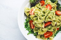 A plate of bow tie pasta, cherry tomatoes, lettuce, and pesto sauce. Original public domain image from <a href="https://commons.wikimedia.org/wiki/File:Pesto_Pasta_(Unsplash).jpg" target="_blank">Wikimedia Commons</a>