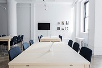 A boardroom with several tables and a television on the wall. Original public domain image from Wikimedia Commons