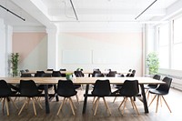 Long tables with black chairs in a large meeting room. Original public domain image from Wikimedia Commons