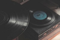 An overhead shot of a vinyl record on a cabinet over a vinyl player. Original public domain image from Wikimedia Commons