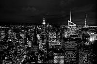 Black and white photo of the New York City skyscraper lights at night. Original public domain image from Wikimedia Commons