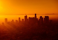 Warm orange sunset behind the skyline of Los Angeles. Original public domain image from Wikimedia Commons