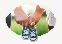 Couple holding baby shoes ripped paper badge, parenthood photo