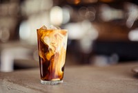 The macro view of a cold latte in a glass cup in Denver. Original public domain image from <a href="https://commons.wikimedia.org/wiki/File:Cold_latte_in_a_glass_cup_(Unsplash).jpg" target="_blank" rel="noopener noreferrer nofollow">Wikimedia Commons</a>