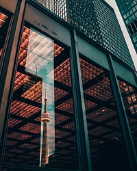The CN Tower in Toronto reflected in the window of a nearby building. Original public domain image from <a href="https://commons.wikimedia.org/wiki/File:Toronto,_Canada_(Unsplash_2EVJTOrmZZs).jpg" target="_blank" rel="noopener noreferrer nofollow">Wikimedia Commons</a>