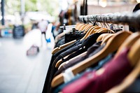 A long row of hangers with clothes in a store in Shoreditch. Original public domain image from Wikimedia Commons