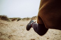 Woman running on the sand. Original public domain image from Wikimedia Commons