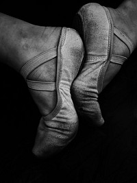 Black and white macro of pair of ballet dancers feet in training. Original public domain image from <a href="https://commons.wikimedia.org/wiki/File:Monochrome_Ballet_Feet_(Unsplash).jpg" target="_blank" rel="noopener noreferrer nofollow">Wikimedia Commons</a>