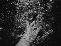 A person moving their hand underwater in Negril which makes bubbles. Original public domain image from <a href="https://commons.wikimedia.org/wiki/File:Bubble_hands_(Unsplash).jpg" target="_blank" rel="noopener noreferrer nofollow">Wikimedia Commons</a>