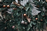 Gold, silver, and white ornaments hung on an evergreen tree. Original public domain image from Wikimedia Commons