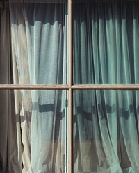 A curtain seen through a window. Original public domain image from <a href="https://commons.wikimedia.org/wiki/File:Window_(Unsplash).jpg" target="_blank" rel="noopener noreferrer nofollow">Wikimedia Commons</a>