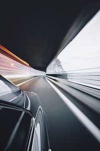Blurry shot from the side of a fast-driving car. Original public domain image from <a href="https://commons.wikimedia.org/wiki/File:DeLorean_(Unsplash).jpg" target="_blank">Wikimedia Commons</a>