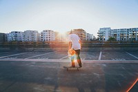 Skateboarder rides his board on a rooftop. Original public domain image from Wikimedia Commons