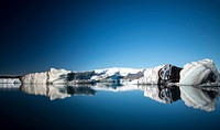 Black mountain covered by snow. Original public domain image from Wikimedia Commons