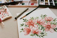 Watercolour illustration of pink flowers on paper on artist's with paintbrushes and pallet, Weeki Wachee. Original public domain image from Wikimedia Commons